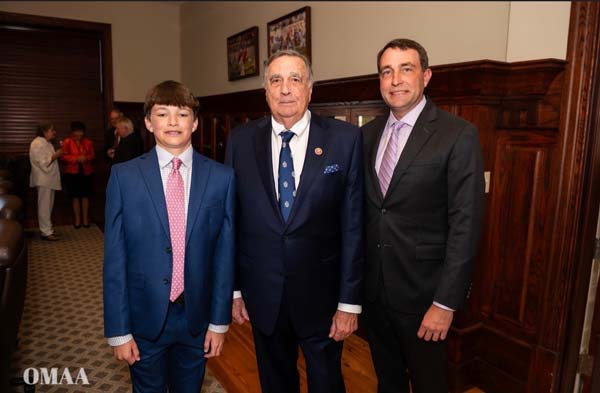 Charles J. Swayze Jr., center, stands with his grandson Charles J. Swayze IV, left, and his son, Charles J. Swayze III, right. 