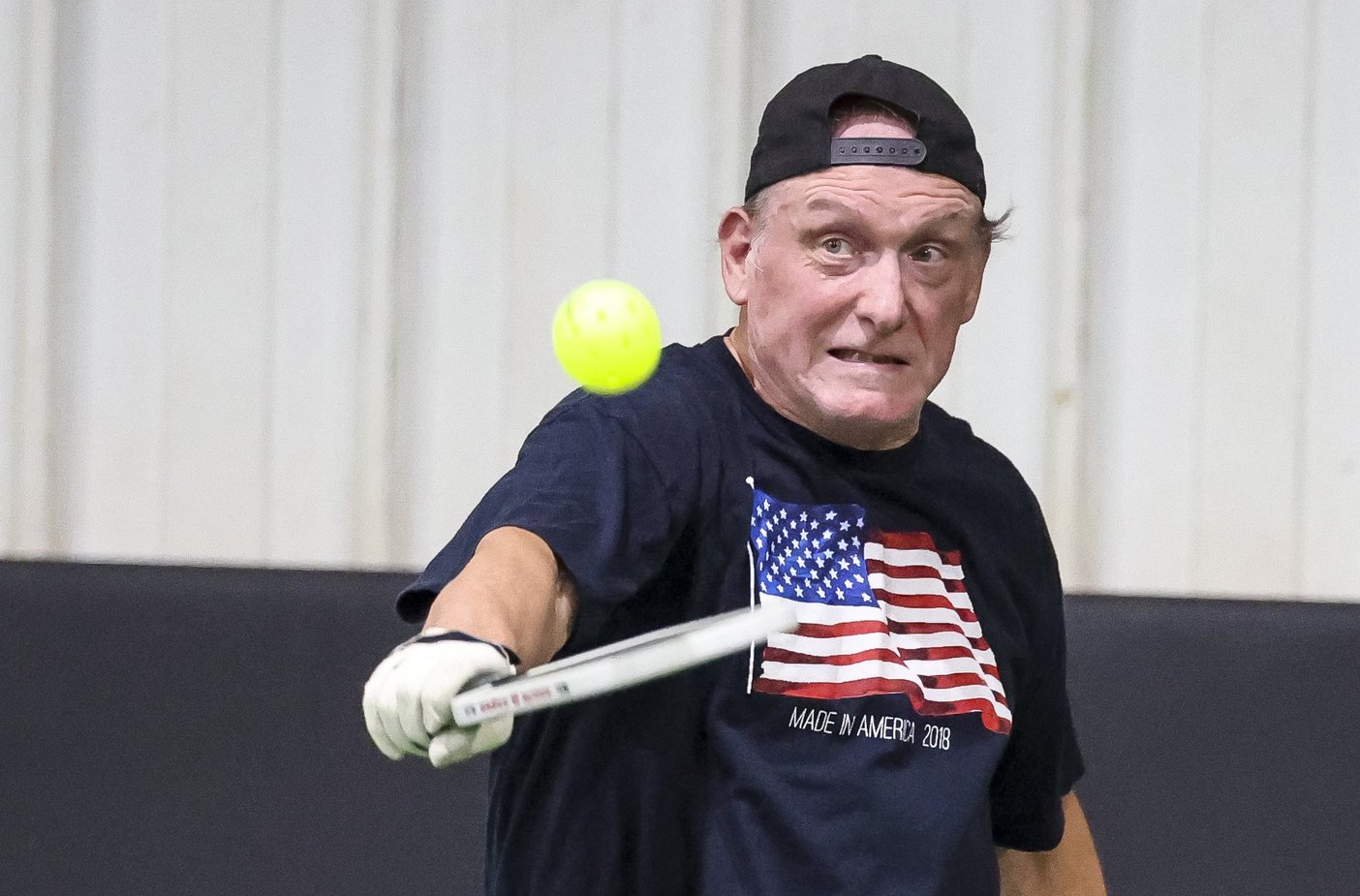 Bottom left: Ambrose Webster returns a shot during a pickleball match on Friday. 