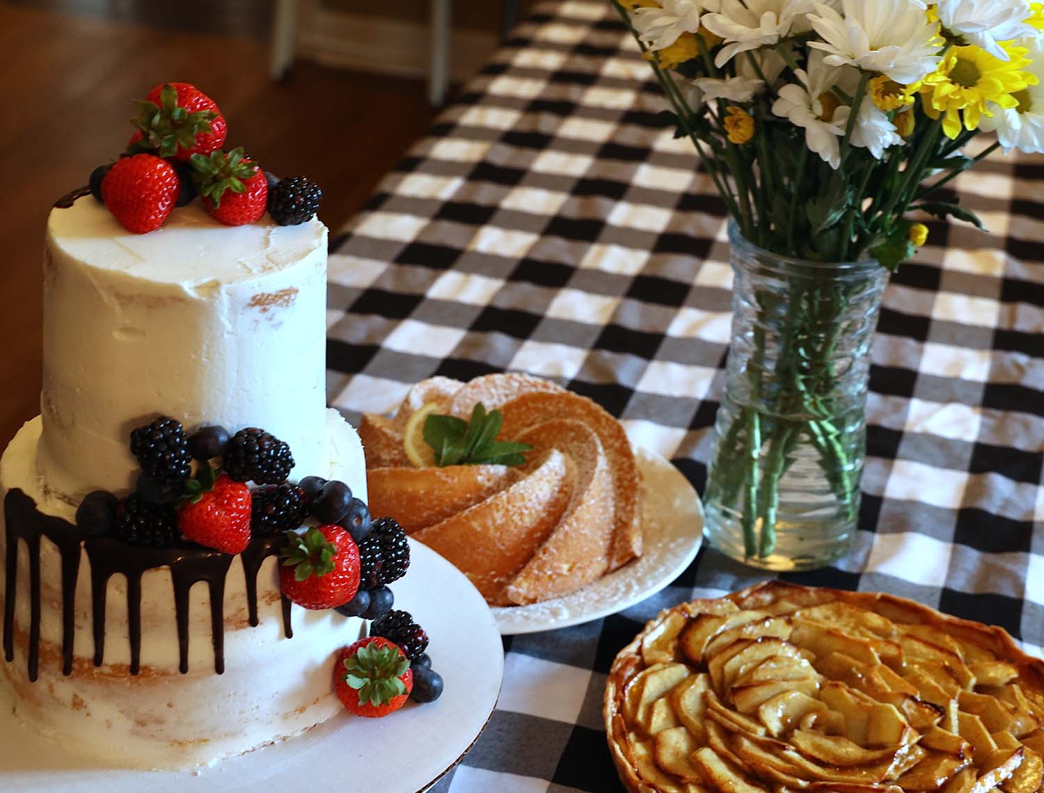 Some of Nevels’ creations are, clockwise from left, a tiered cake, a tart and a molded cake topped with confectioners’ sugar.