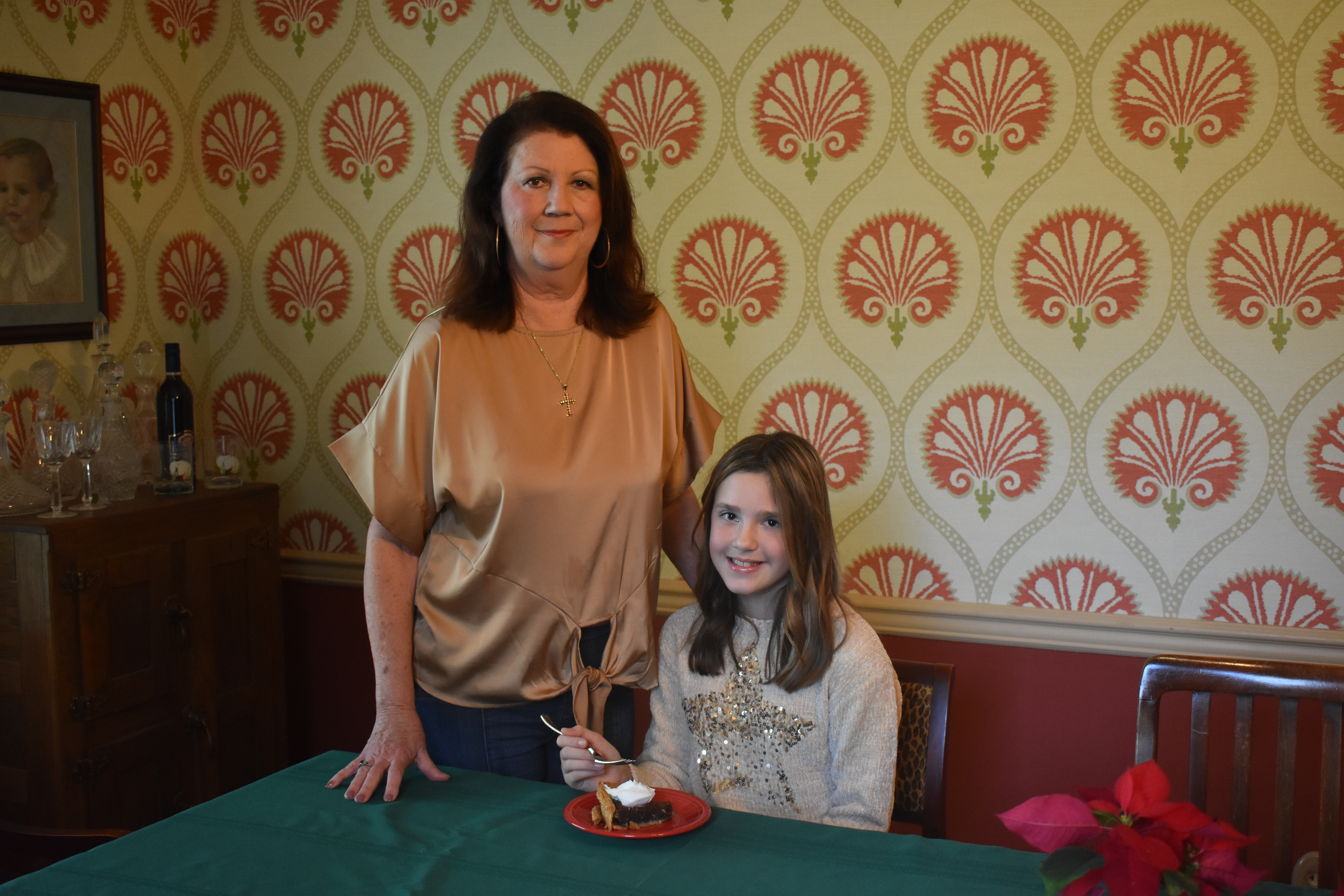 Lee Ann Flemming, left, is with her granddaughter, Leila Rose Flemming, at her dining room table in her home in Cruger. Leila Rose is about to take a bite of chocolate pie — Lee Ann’s recipe that she used when she was a food stylist for “The Help.” Lee Ann’s food column on Page 7B is No. 1,000. Her weekly column has appeared in the Commonwealth for almost 20 years.