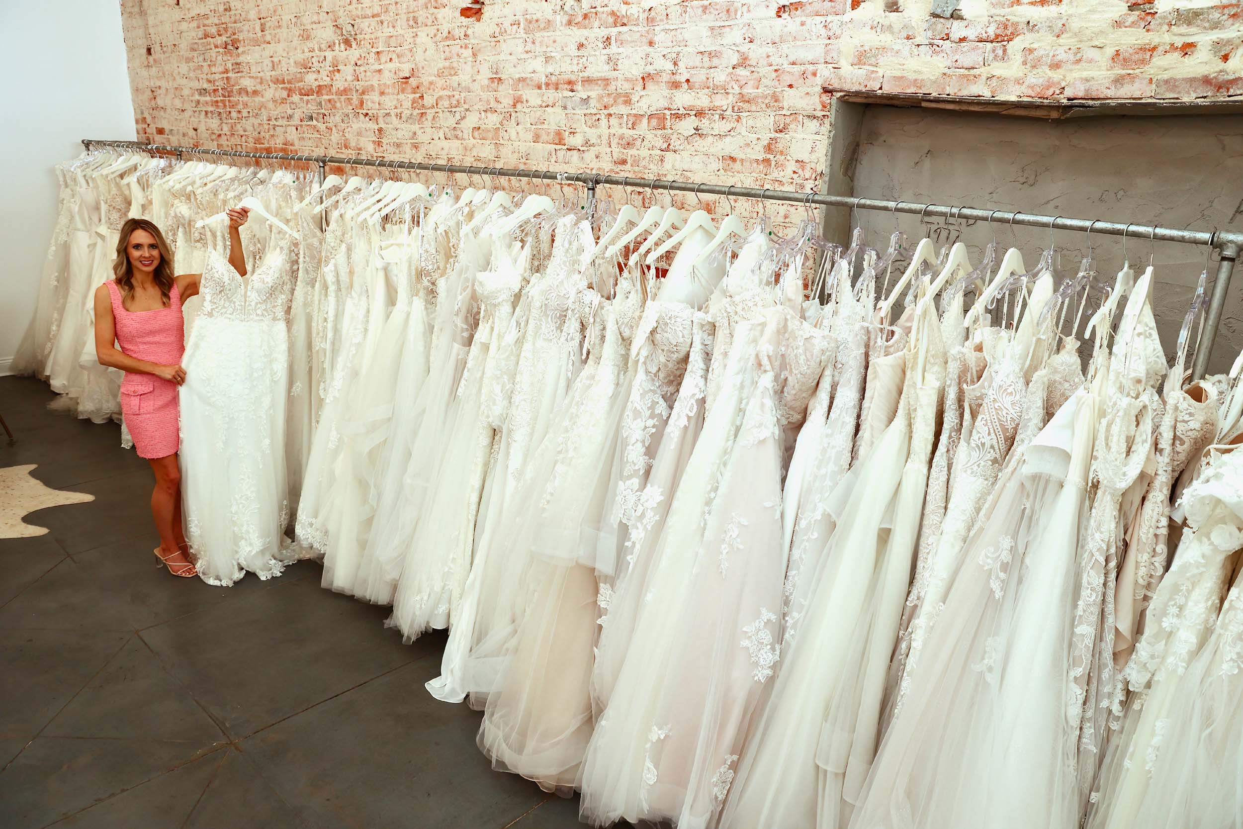 Mary George Dodson picks a gown from the more than 125 wedding dresses she has in the store. Brides-to-be try them on, pick one and it is ordered in the right size. 