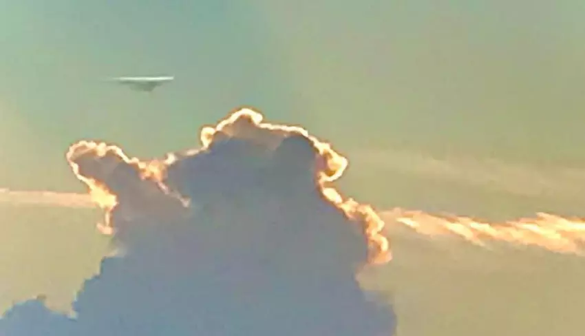 A UFO carefully monitoring a cloud, perhaps studying our weather patterns.  Scientists come in all species!  Near Bee Lake.  Holmes County, MS.