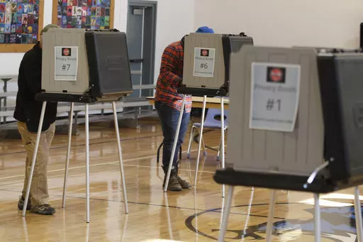 Voters fill out ballots at an elementary school in Tesuque, N.M., on Tuesday, Nov. 8, 2022. A federal judge has ruled, Tuesday, April 2, 2024, that New Mexico election regulators violated public disclosure provisions of the National Voter Registration Act in withholding voter rolls from a conservative group and its public online database. (AP Photo/Morgan Lee, File)