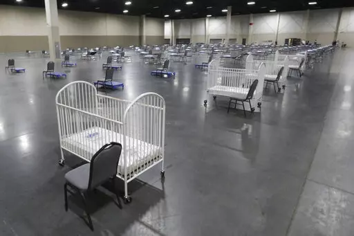 Cots and cribs are arranged at the Mountain America Expo Center in Sandy, Utah, on April 6, 2020, as an alternate care site or for hospital overflow amid the COVID-19 pandemic. According to a National Center for Health Statistics report released on Wednesday, Feb. 23, 2022, maternal mortality rates for U.S. women climbed higher in the pandemic's first year, continuing a trend that disproportionately affects Black mothers. (AP Photo/Rick Bowmer, File)