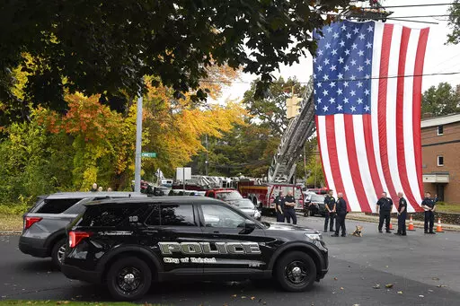 Police officers from Bristol, Conn. gather with other towns at the scene where two police officers killed, Thursday, Oct. 13, 2022, in Bristol, Conn. The deaths of two Connecticut police officers and the wounding of a third during an especially violent week for police across the U.S. fit into a grim pattern, law enforcement experts say. Even as the number of officers has dropped in the past two years, the number being targeted and killed has risen. (AP Photo/Jessica Hill, File)