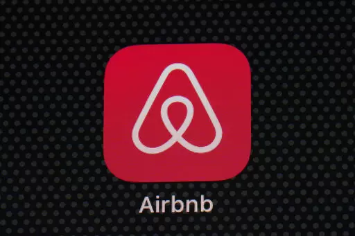 The Airbnb app icon is displayed on an iPad screen in Washington, D.C., on May 8, 2021.  NerdWallet looked at the price of 1,000 Airbnb listings and compared them to the cost of hotels. Airbnbs can be an affordable alternative to hotels, particularly for longer stays, large groups and for people who need a washer and dryer or kitchen. But beware of vacation rental cleaning fees that can make the price skyrocket, and take advantage of discounts for monthlong stays.  (AP Photo/Patrick Semansky, Fi