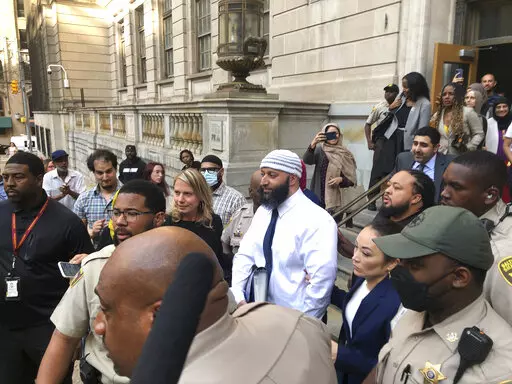Adnan Syed, center, leaves the Elijah E. Cummings Courthouse, Monday, Sept. 19, 2022, in Baltimore. A judge has ordered the release of Syed after overturning his conviction for a 1999 murder that was chronicled in the hit podcast “Serial.” (AP Photo/Brian Witte)