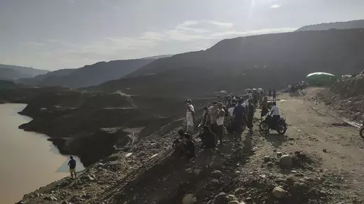 Miners, rescuers and local residents look at the jade mine site where a landslide accident took place in Hpakant township, Kachin state, Myanmar Sunday, Aug. 13, 2023. A landslide at the jade mine left scores of people missing, and a search and rescue operation was underway on Monday, a rescue official said. (AP Photo)