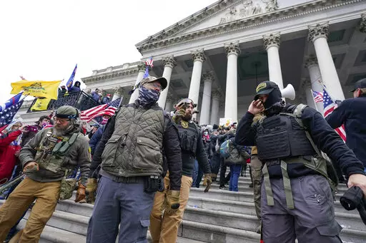 Members of the Oath Keepers on the East Front of the U.S. Capitol on Jan. 6, 2021, in Washington. A member of the Oath Keepers who traveled to Washington before the Jan. 6 attack at the U.S. Capitol testified during the seditious conspiracy case against Oath Keepers founder Stewart Rhodes and four associates on Wednesday, Oct. 12, 2022, about a massive cache of weapons the far-right extremist group stashed in a Virginia hotel room. (AP Photo/Manuel Balce Ceneta)