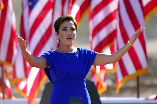 Arizona Republican gubernatorial candidate Kari Lake arrives to a rally with former President Donald Trump on Oct. 9, 2022, in Mesa, Ariz. The Republicans running for Arizona's three top statewide offices have said they would not have signed off on the presidential results if they had held office in 2020 and have signaled that they want to overhaul the battleground state's elections.(AP Photo/Matt York, File)