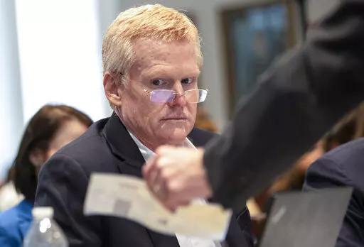 Alex Murdaugh looks over evidence of a check brought to him and his attorneys during his double murder trial at the Colleton County Courthouse on Tuesday, Feb. 7, 2023, in Walterboro, S.C. The 54-year-old attorney is standing trial on two counts of murder in the shootings of his wife and son at their Colleton County home and hunting lodge on June 7, 2021. (Andrew J. Whitaker/The Post And Courier via AP, Pool)/The Post And Courier via AP, Pool)