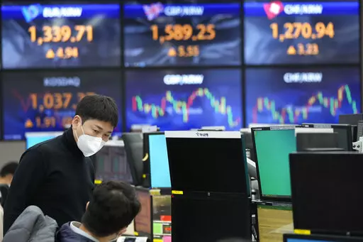 Currency traders talk each other at the foreign exchange dealing room of the KEB Hana Bank headquarters in Seoul, South Korea, Wednesday, Nov. 17, 2021. Asian shares slipped Wednesday despite a rally on Wall Street. (AP Photo/Ahn Young-joon)
