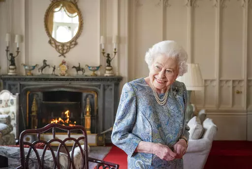 Britain's Queen Elizabeth II smiles while receiving the President of Switzerland Ignazio Cassis and his wife Paola Cassis during an audience at Windsor Castle in Windsor, England, April 28, 2022. Buckingham Palace says Queen Elizabeth II will not attend the opening of Parliament on Tuesday amid ongoing mobility issues. The palace said in a statement Monday, May 9 that the decision was made in consultation with her doctors and that the 96-year-old monarch had “reluctantly’’ decided not to a
