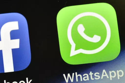 The WhatsApp icon is seen on an iPhone in Gelsenkirchen, Germany, on Nov. 15, 2018. People around the world are reporting problems sending and receiving messages on the popular chat app WhatsApp. According to Downdetector, which tracks outage reports, people started reporting problems around 3 a.m. EDT. on Tuesday, Oct. 24, 2022. (AP Photo/Martin Meissner, File)