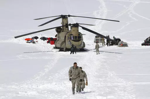  Capt. Corey Wheeler, front, commander of B Company, 1st Battalion, 52nd Aviation Regiment at Fort Wainwright, Alaska, walks away from a Chinook helicopter that landed on the glacier near Denali, April 24, 2016, on the Kahiltna Glacier in Alaska. The U.S. Army helped set up base camp on North America's tallest mountain. The U.S. Army is poised to revamp its forces in Alaska to better prepare for future cold-weather conflicts, and it is expected to replace the larger, heavily equipped Stryker Bri