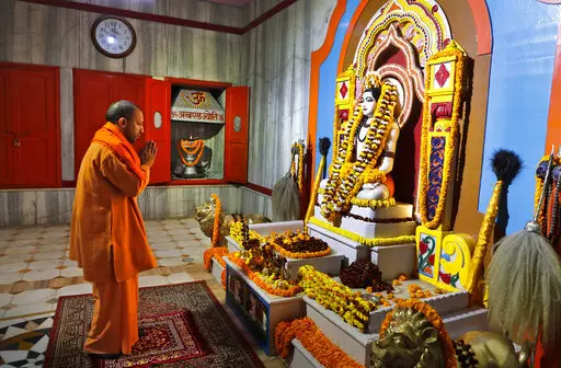 Uttar Pradesh Chief Minister Yogi Adityanath prays at a temple in the morning before going to file his nomination papers for the state assembly elections in Gorakhpur, India, Feb. 5, 2022. The polls are a referendum on the saffron-robed Adityanath, a poster figure for the Hindu right-wing, who some analysts believe is vying to be the next prime minister. Over 150 million people are expected to vote in the state across seven phases starting Thursday before results are declared in March. (AP Photo