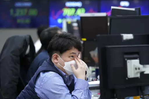 A currency trader watches monitors at the foreign exchange dealing room of the KEB Hana Bank headquarters in Seoul, South Korea, Thursday, Jan. 19, 2023. Asian shares were trading mixed Thursday, as investors grew cautious after Wall Street's biggest pullback of the year. (AP Photo/Ahn Young-joon)