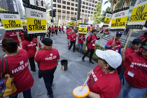 Striking hotel workers rally outside the Intercontinental Hotel after walking off their job early Sunday, July 2, 2023, in downtown Los Angeles. (AP Photo/Damian Dovarganes)