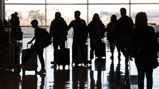 People pass through Salt Lake City International Airport Wednesday, Jan. 11, 2023, in Salt Lake City. Artificial intelligence chatbots like ChatGPT offer a novel way to research travel plans. They provide clear, easy-to-read suggestions that can be customized to almost any personal preference, leading to off-the-beaten-path suggestions that no guidebook or web search could provide. (AP Photo/Rick Bowmer, File)