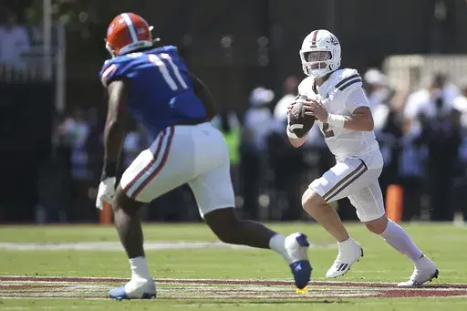 Mississippi State quarterback Blake Shapen (2) looks to pass against Florida defensive end Kelby Collins (11) during the first half of an NCAA college football game in Starkville, Miss., Saturday, Sept. 21, 2024. (AP Photo/James Pugh)