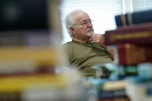 Paul Phelps, 76, of Alexandria, Va., works in the genealogy room at Hollin Hall Senior Center in Alexandria, Va., Thursday, Oct. 13, 2022. The news that 70 million people will see an 8.7% boost in their Social Security checks comes just weeks before the midterm elections, but it's unlikely to give Democrats the edge they're desperately seeking at the polls Nov. 8. (AP Photo/Susan Walsh, File)