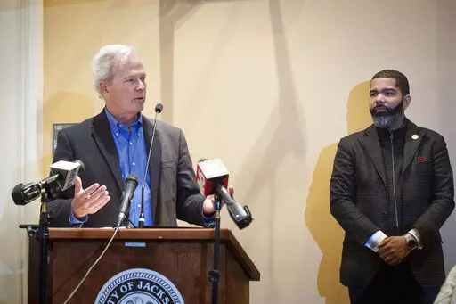 Ted Henifin, left, the City of Jackson water system third-party administrator, addresses media questions during a news conference at City Hall as Jackson Mayor Chokwe Antar Lumumba listens on Dec. 5, 2022, in Jackson, Miss. A bill before the Mississippi Legislature that would transfer the capital city's troubled water system to a new regional entity could be motivated by a desire by state officials to access a large pot of federal dollars earmarked for the city, according to Henifin, Jackson's f