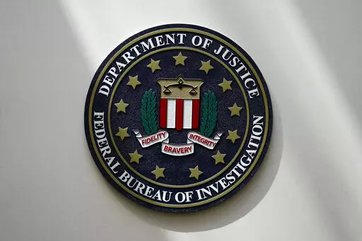 An FBI seal is seen on a wall on Aug. 10, 2022, in Omaha, Neb. The FBI sounded the alarm Monday, Dec. 19, about an explosive increase in teenage boys being targeted online and extorted for money after being tricked into sending sexually explicit pictures. (AP Photo/Charlie Neibergall, File)