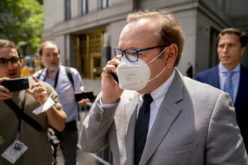 Kevin Spacey leaves court after testifying in a civil lawsuit, Thursday, May 26, 2022, in New York. British prosecutors have charged Spacey with four counts of sexual assault against three men. The 62-year-old double Academy Award winner was questioned by British police in 2019 about claims by several men that he had assaulted them. The U.K. charges were announced Thursday, as Spacey was testifying in a courtroom in New York City in a civil lawsuit. (AP Photo/John Minchillo)