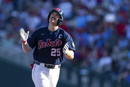 Mississippi's Tim Elko (25) runs the bases after hitting a home run against Arkansas in the first inning during an NCAA College World Series baseball game, Monday, June 20, 2022, in Omaha, Neb. (AP Photo/John Peterson)