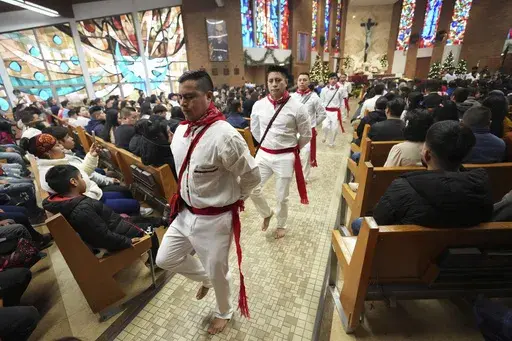 Lucas Lopez leads a traditional Guatemalan dance during Mass celebrating the feast day of the Black Christ of Esquipulas at St. Mary's Catholic Church in Worthington, Minnesota, Sunday, Jan. 12, 2025. (AP Photo/Abbie Parr)