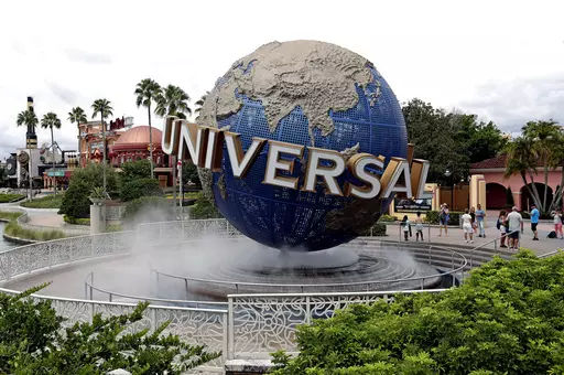 In this Aug. 5, 2019 file photo, guests cool off under a water mist by the globe at Universal Studios City Walk at Universal Studios Florida in Orlando, Fla. Universal Orlando Resort's new theme park opening next year will feature lands devoted to Super Nintendo World characters, the “Fantastic Beasts” films and the “How to Train Your Dragon” film franchise, theme park officials said Tuesday, Jan. 30, 2024. At the center of what will be Universal Orlando's fourth theme park, Universal Ep