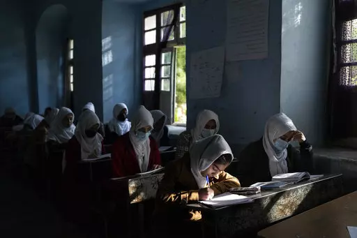 Afghan girls participate in a lesson at Tajrobawai Girls High School in Herat, Afghanistan on Nov. 25, 2021. In a surprise decision the hardline leadership of Afghanistan's new rulers has decided against opening educational institutions to girls beyond Grade six, a Taliban official said Wednesday, March 23, 2022 on the first day of Afghanistan's new school year. (AP Photo/Petros Giannakouris, File)