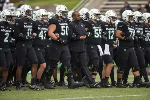Marshall players and coaches take the field against UAB in an NCAA college football game on Saturday, Nov. 13, 2021, at Joan C. Edwards Stadium in Huntington W.Va. On Tuesday, March 29, 2022, Conference USA announced in a joint statement with Marshall, Old Dominion and Southern Miss that it has reached a resolution with the three schools to expedite their early move to the Sun Belt. (Sholten Singer/The Herald-Dispatch via AP, File)