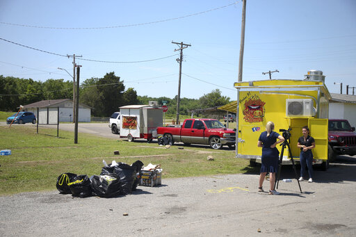 News crews film at the scene of a fatal shooting that happened at a Memorial Day event in Taft, Okla., on Sunday, May 29, 2022. (Ian Maule/Tulsa World via AP)