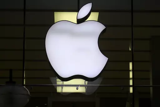 The Apple logo is illuminated at a store in the city center of Munich, Germany, Dec. 16, 2020. A potential redesign of two Apple Watch models, the Series 9 and Ultra 2, that would exclude the blood oxygen sensor has been approved by the U.S. Customs and Border Protection, according to a Monday, Jan. 15, 2024, court filing by Masimo, a Southern California company pursuing the patent claim. (AP Photo/Matthias Schrader, File)
