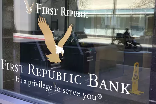 First Republic Bank signs and logos are attached to a window at a branch location, Wednesday, April 26, 2023, in Boston. Regulators seized troubled First Republic Bank early Monday and sold all of its deposits and most of its assets to JPMorgan Chase Bank in a bid to head off further banking turmoil in the U.S. (AP Photo/Steven Senne, File)