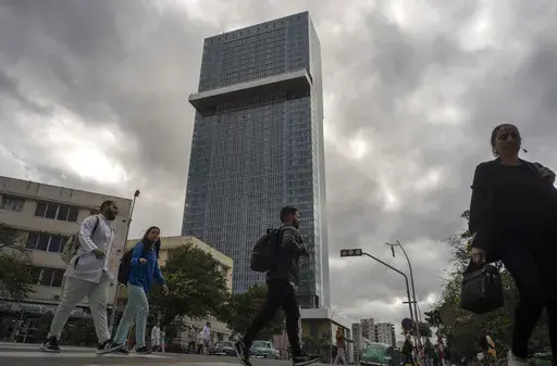People walk past the Selection La Habana new hotel, managed by Spanish chain Iberostar, in Havana, Cuba, Friday, Jan. 24, 2025. (AP Photo/Ramon Espinosa)