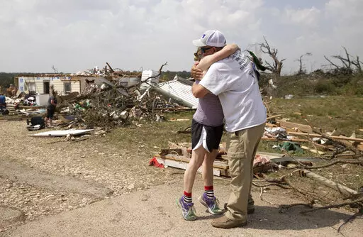 Michelle Light hugs her uncle Paul Bales on Wednesday April 13, 2022, a day after a tornado destroyed her home on FM 2843 and Cedar Valley Road near Salado, Texas. Nearly two dozen people were injured when tornadoes swept through central Texas as part of a storm system that’s expected to spawn more twisters and damaging winds Wednesday (Jay Janner/Austin American-Statesman via AP)