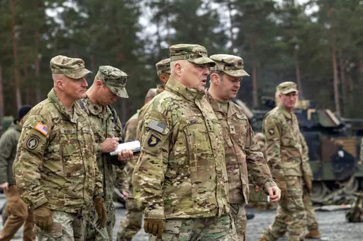 In this image provided by the U.S. Army, U.S. Chairman of the Joint Chiefs of Staff Gen. Mark Milley meets with U.S. Army leaders responsible for the collective training of Ukrainians at Grafenwoehr Training Area, Grafenwoehr, Germany, on Monday, Jan. 16, 2023. At left is Brig. Gen. Joseph E. Hilbert, who is the commanding general for the 7th Army Training Command. Milley visited the training site in Germany for Ukrainian forces and met with troops and commanders.(Staff Sgt. Jordan Sivayavirojna