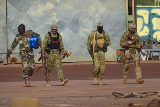 This undated photograph handed out by French military shows three Russian mercenaries, right, in northern Mali. Western officials say violence against civilians in Mali has risen in the year since hundreds of Russian mercenaries have started working alongside the West African country's armed forces to stem a decade-long insurgency by Islamic extremists. Diplomats, analysts and human rights groups say extremists linked to al-Qaida and the Islamic State group have only gotten stronger and there's 