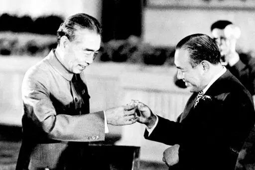 Chinese Premier Zhou Enlai, left, and Japanese Prime Minister Kakuei Tanaka toast each other at a banquet in the Hall of the People in Beijing on Sept. 28, 1972. Thursday, Sept. 29, 2022, marks the 50th anniversary of a historic communique for Japan to normalize relations with China that Tanaka signed with Zhou. (AP Photo, File)