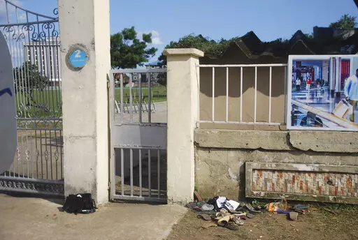 A view of sandles outside Kings Assembly Pentecostal church, following a stampede in Port Harcourt, Nigeria, Saturday, May 28, 2022. Police say a stampede at a church charity event in southern Nigeria has left at least 31 people dead and seven injured. One witness said the dead included a pregnant woman and “many children.” Police said the stampede took place at an annual “Shop for Free” program organized by the Kings Assembly Pentecostal church in Rivers state. Such events are common in