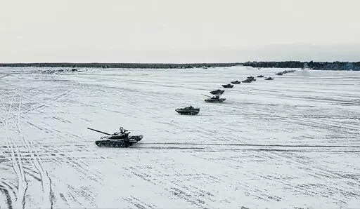 In this photo taken from video and released by the Russian Defense Ministry Press Service on Friday, Feb. 4, 2022, tanks and armored vehicles move during the Belarusian and Russian joint military drills at Brestsky firing range, Belarus. With Russia carrying out a massive military buildup near Ukraine and the West roundly rejecting Moscow’s security demands, a window for diplomacy in the crisis appears to be closing. But even as Moscow continues to bolster its forces and holds sweeping war gam