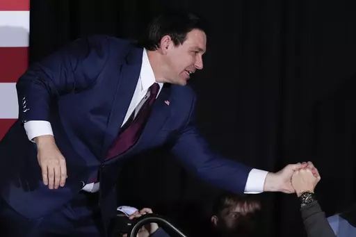 Republican presidential candidate Florida Gov. Ron DeSantis greets supporters during a caucus night party, Monday, Jan. 15, 2024, in West Des Moines, Iowa. (AP Photo/Charlie Neibergall)