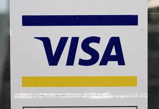 A Visa sign is displayed on the front door of a local business, April 27, 2021, in Urbandale, Iowa. Visa has announced major changes to how its credit and debit cards will operate in the U.S. Features in the works will lead to Americans to carry fewer physical cards in their wallets and make the 16-digit credit or debit card number printed on every physical card increasingly irrelevant. The new features unveiled Wednesday, May 15, 2024 will be some of the biggest changes to how payments operate 