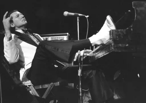 CORRECTS LOCATION OF DEATH TO DESOTO COUNTY, MISSISSIPPI - FILE - Jerry Lee Lewis props his foot on the piano as he lays back and acknowledges the applause of fans during the fifth annual Rock 'n' Roll Revival at New York's Madison Square Garden on March 14, 1975. Spokesperson Zach Furman said Lewis died Friday morning, Oct. 28, 2022, at his home in DeSoto County, Miss., south of Memphis, Tenn. He was 87. (AP Photo/Rene Perez, File)
