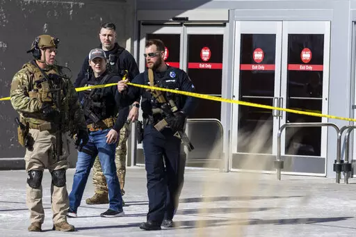 Law enforcement officers are pictured at the scene of a reported shooting at a Target store in Omaha, Neb., on Tuesday, Jan. 31, 2023. Omaha Police Chief Todd R. Schmaderer says city police confronted and shot a man with an assault rifle. (Chris Machian/Omaha World-Herald via AP)