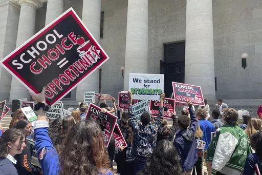 Students and parents rally at the Ohio Statehouse in support of possible changes that would increase eligibility for taxpayer-funded school vouchers to K-12 students statewide, May 17, 2023, in Columbus, Ohio. National Republicans are poised to support “universal school choice” as part of the policy platform they adopt at the 2024 Republican National Convention, which starts next week on Monday, July 15, 2024. (AP Photo/Samantha Hendrickson, File)