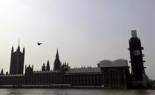 Britain's Houses of Parliament, covered in hoarding and scaffolding as it undergoes restoration work to repair the crumbling building, in London, Wednesday, April 17, 2019. British lawmakers are warning that the country's Parliament building is at “real and rising” risk of destruction. The House of Commons Public Accounts Committee said Parliament is “leaking, dropping masonry and at constant risk of fire,” as well as riddled with asbestos. The committee said Wednesday, May 17, 2023 that