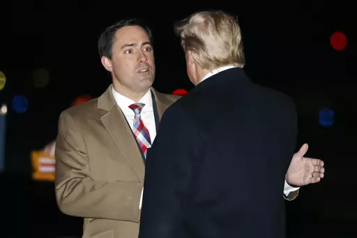 President Donald Trump greets Ohio Secretary of State Frank LaRose, Jan. 9, 2020, as he arrives at Toledo Express Airport, in Swanton, Ohio. The Republican secretaries of state in Ohio, West Virginia and Missouri all have promoted their states’ elections as fair and secure. Yet each also is navigating a fine line on how to address election fraud conspiracies, as they eye campaigns for U.S. Senate or governor in 2024. (AP Photo/ Jacquelyn Martin, File)